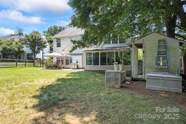 5630 Cambridge Bay Dr, Charlotte, NC 28269 - back of property featuring a patio, a sunroom, and an outdoor structure