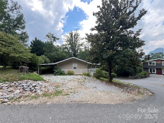 130 Sherwood Dr, Lake Lure, NC 28746 - view of property exterior with gravel driveway and an attached carport