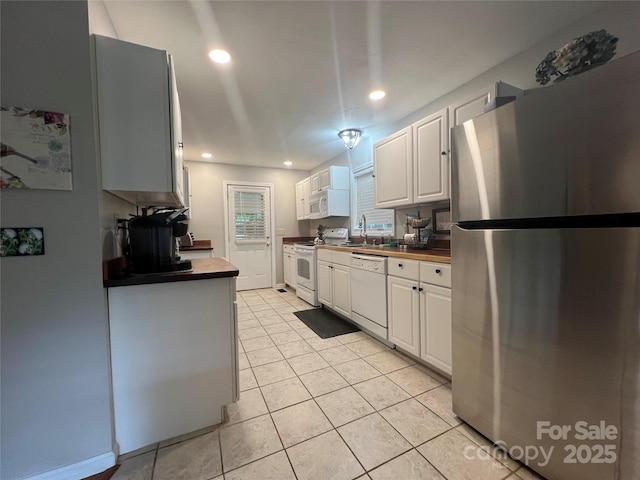 130 Sherwood Dr, Lake Lure, NC 28746 - kitchen featuring white appliances, dark countertops, white cabinets, light tile patterned flooring, and recessed lighting