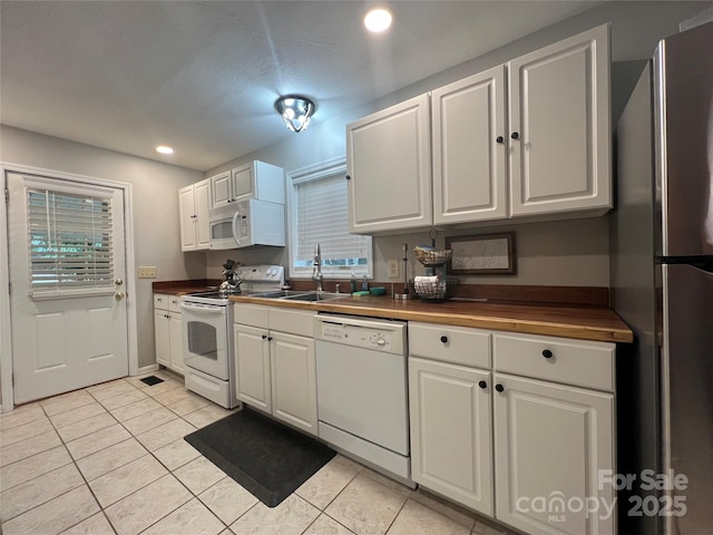 130 Sherwood Dr, Lake Lure, NC 28746 - kitchen with white appliances, light tile patterned floors, white cabinets, recessed lighting, and butcher block countertops