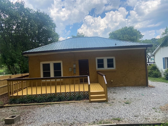 729 Elm St, Salisbury, NC 28144 - rear view of house with stucco siding, a metal roof, and a deck