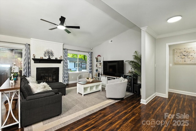 7627 Walnut Wood Dr, Charlotte, NC 28227 - living room with a ceiling fan, a brick fireplace, dark wood-style flooring, ornamental molding, and vaulted ceiling