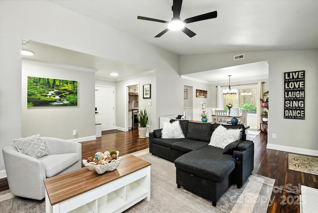 7627 Walnut Wood Dr, Charlotte, NC 28227 - living room featuring wood finished floors, a chandelier, ornamental molding, and ceiling fan