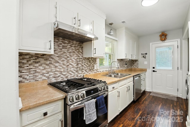 7627 Walnut Wood Dr, Charlotte, NC 28227 - kitchen with stainless steel appliances, under cabinet range hood, dark wood finished floors, white cabinetry, and light countertops