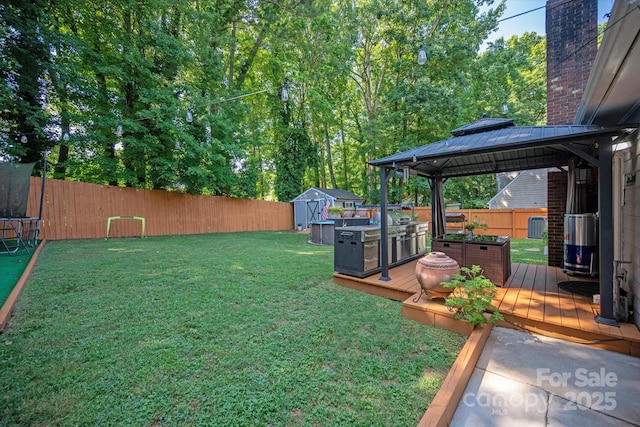 7627 Walnut Wood Dr, Charlotte, NC 28227 - fenced backyard featuring a gazebo, a storage unit, and a wooden deck