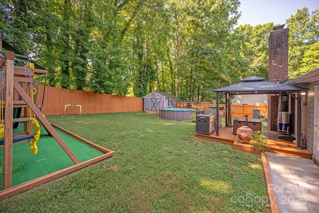 7627 Walnut Wood Dr, Charlotte, NC 28227 - fenced backyard featuring a gazebo, a storage unit, a deck, and a playground