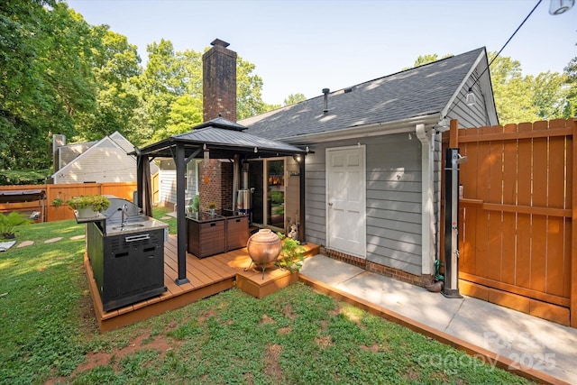 7627 Walnut Wood Dr, Charlotte, NC 28227 - rear view of house featuring a gazebo, a gate, a wooden deck, a chimney, and roof with shingles