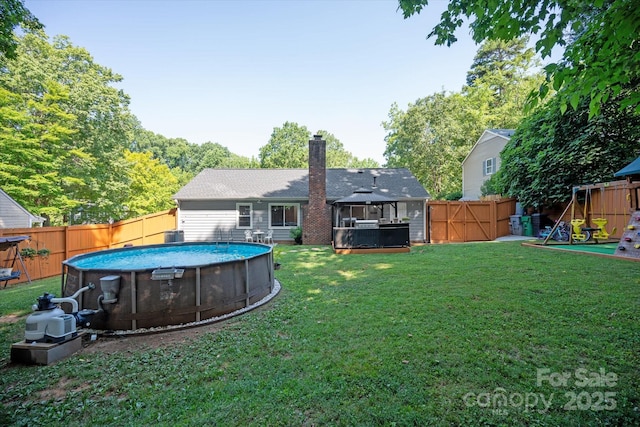 7627 Walnut Wood Dr, Charlotte, NC 28227 - rear view of house with a gazebo, a chimney, a fenced backyard, and a playground
