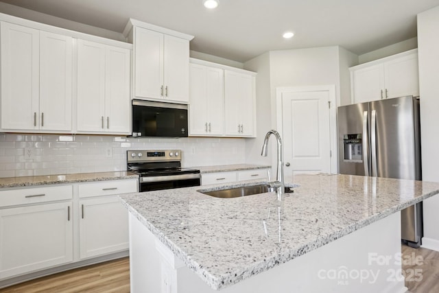 1997 Paddlewheel Dr, Stanley, NC 28164 - kitchen with appliances with stainless steel finishes, white cabinets, light stone counters, and recessed lighting