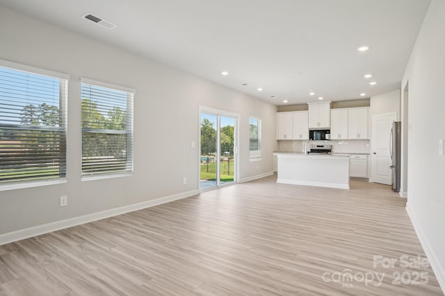 1997 Paddlewheel Dr, Stanley, NC 28164 - unfurnished living room featuring light wood-style flooring and recessed lighting