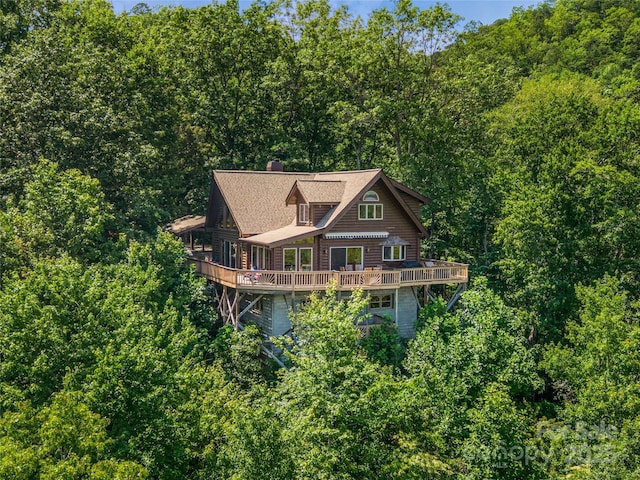 220 Circle Pines Dr, Rosman, NC 28772 - rear view of house featuring a wooden deck, a wooded view, and a chimney