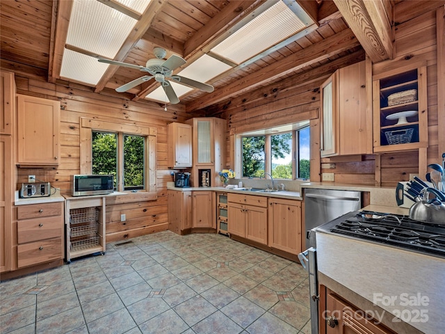 220 Circle Pines Dr, Rosman, NC 28772 - kitchen featuring a wood ceiling with exposed beams, light brown cabinetry, wooden walls, stainless steel microwave, and light countertops