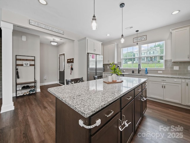 8810 Crape Myrtle Dr, Stanfield, NC 28163 - kitchen featuring freestanding refrigerator, dark wood finished floors, backsplash, white cabinets, and recessed lighting