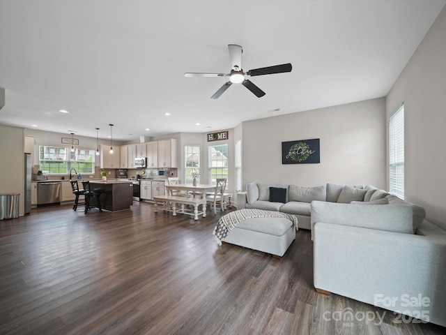 8810 Crape Myrtle Dr, Stanfield, NC 28163 - living area with plenty of natural light, dark wood finished floors, recessed lighting, and a ceiling fan