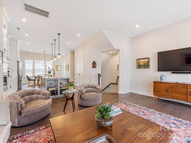 5018 Harrowsmith Ln, Charlotte, NC 28204 - living area with dark wood-style floors and recessed lighting