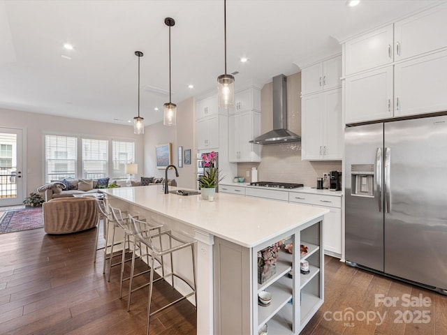 5018 Harrowsmith Ln, Charlotte, NC 28204 - kitchen featuring appliances with stainless steel finishes, wall chimney range hood, open floor plan, dark wood-type flooring, and white cabinetry