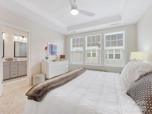 5018 Harrowsmith Ln, Charlotte, NC 28204 - bedroom featuring a tray ceiling, multiple windows, light tile patterned flooring, and ensuite bath