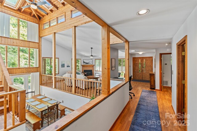 6724 Riverfront Dr, Charlotte, NC 28216 - hallway featuring a skylight, hardwood / wood-style floors, recessed lighting, and wooden walls