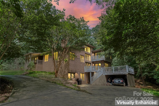 6724 Riverfront Dr, Charlotte, NC 28216 - rear view of property featuring concrete driveway, a balcony, a carport, and stairway