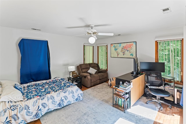 6724 Riverfront Dr, Charlotte, NC 28216 - bedroom with wood finished floors, an office area, and a ceiling fan