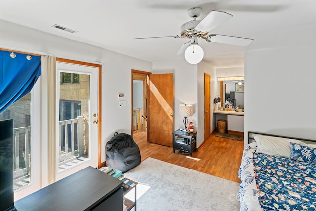 6724 Riverfront Dr, Charlotte, NC 28216 - bedroom with access to exterior, wood finished floors, a ceiling fan, and ensuite bath