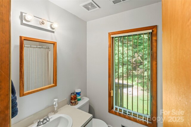 6724 Riverfront Dr, Charlotte, NC 28216 - bathroom featuring plenty of natural light, vanity, and a shower with curtain