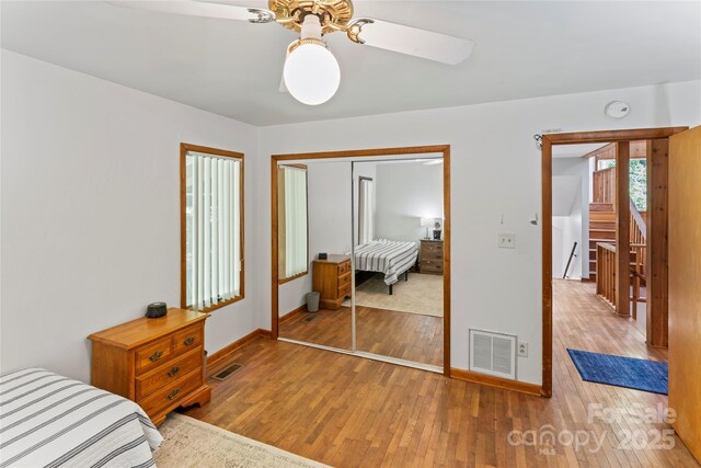 6724 Riverfront Dr, Charlotte, NC 28216 - bedroom with wood-type flooring, a closet, and a ceiling fan