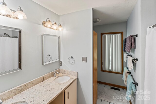 6724 Riverfront Dr, Charlotte, NC 28216 - full bath with double vanity and tile patterned flooring
