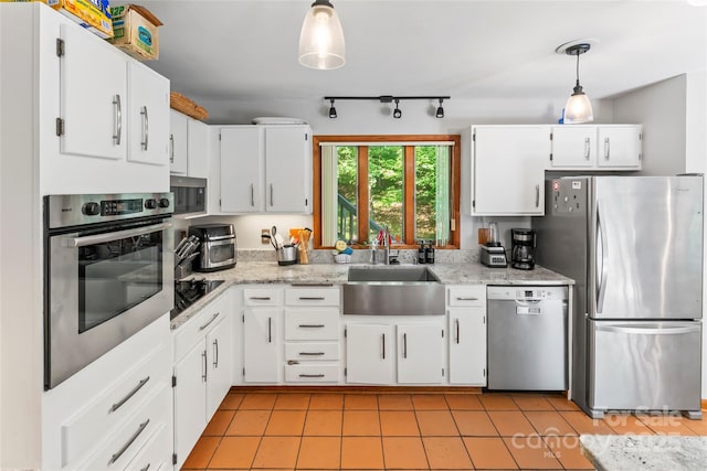 6724 Riverfront Dr, Charlotte, NC 28216 - kitchen with appliances with stainless steel finishes, rail lighting, and white cabinetry