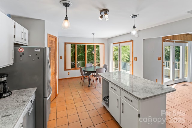 6724 Riverfront Dr, Charlotte, NC 28216 - kitchen featuring freestanding refrigerator, light tile patterned floors, and plenty of natural light
