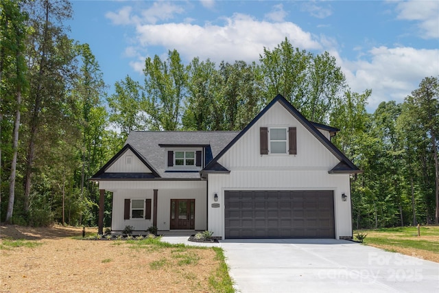 5005 Oconee Dr, Stanley, NC 28164 - modern farmhouse with driveway, an attached garage, a porch, and a shingled roof