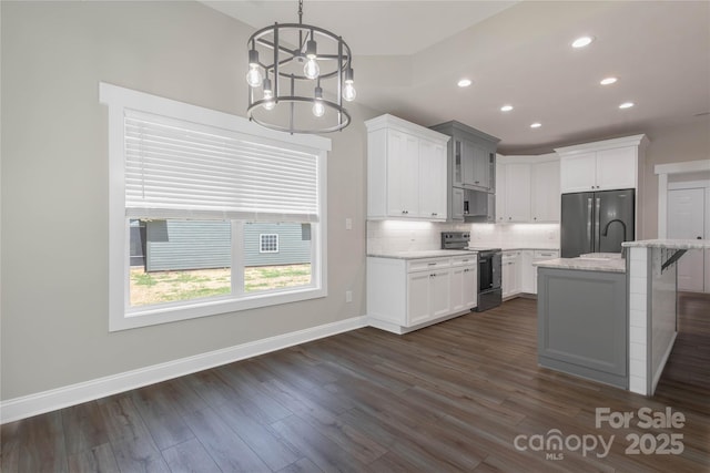 5005 Oconee Dr, Stanley, NC 28164 - kitchen with appliances with stainless steel finishes, a chandelier, tasteful backsplash, white cabinetry, and recessed lighting
