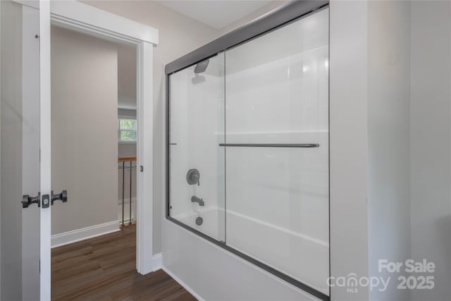 5005 Oconee Dr, Stanley, NC 28164 - bathroom with bath / shower combo with glass door and wood finished floors