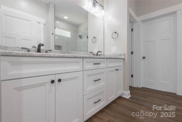 5005 Oconee Dr, Stanley, NC 28164 - full bath featuring double vanity, tiled shower, and wood finished floors