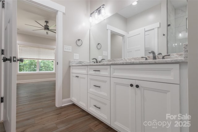 5005 Oconee Dr, Stanley, NC 28164 - full bath featuring double vanity, wood finished floors, ceiling fan, and a shower with door