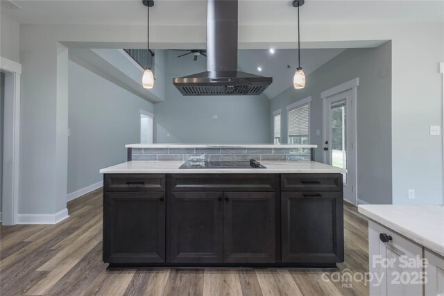 5009 Oconee Dr, Stanley, NC 28164 - kitchen with island range hood, black electric cooktop, light countertops, and decorative light fixtures