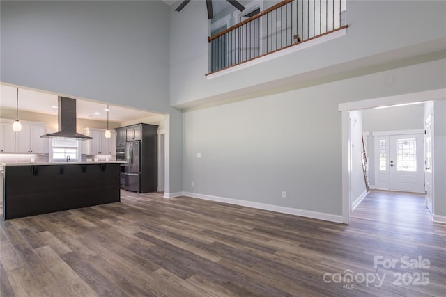 5009 Oconee Dr, Stanley, NC 28164 - unfurnished living room with a towering ceiling, dark wood-style flooring, and a ceiling fan