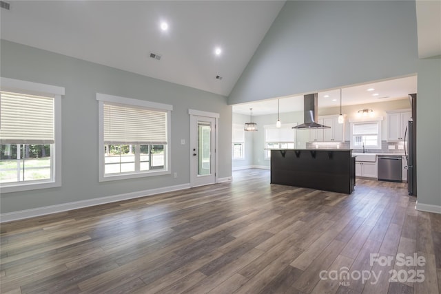 5009 Oconee Dr, Stanley, NC 28164 - unfurnished living room with dark wood-type flooring and high vaulted ceiling