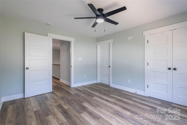 5009 Oconee Dr, Stanley, NC 28164 - unfurnished bedroom with wood finished floors, a closet, and a ceiling fan