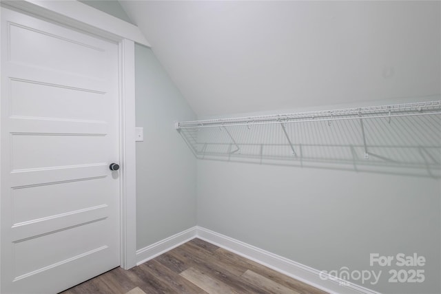 5009 Oconee Dr, Stanley, NC 28164 - walk in closet with lofted ceiling and dark wood-style floors