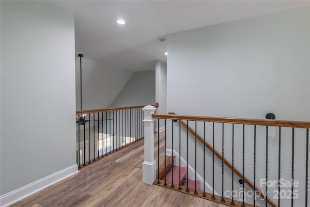5009 Oconee Dr, Stanley, NC 28164 - staircase featuring wood finished floors, vaulted ceiling, and recessed lighting