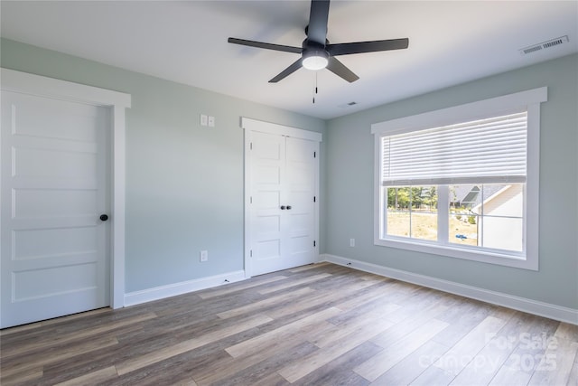 5009 Oconee Dr, Stanley, NC 28164 - unfurnished bedroom featuring wood finished floors, a closet, and ceiling fan