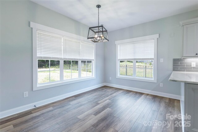 5009 Oconee Dr, Stanley, NC 28164 - unfurnished dining area featuring a chandelier, dark wood finished floors, and healthy amount of natural light