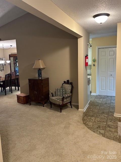 1678 Robins Nest Ct Unit B, Gastonia, NC 28054 - hallway featuring carpet, a chandelier, and a textured ceiling