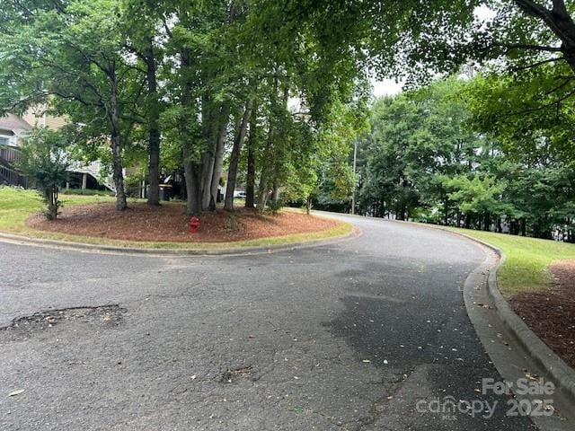 1678 Robins Nest Ct Unit B, Gastonia, NC 28054 - view of asphalt road with curbs and view of scattered trees