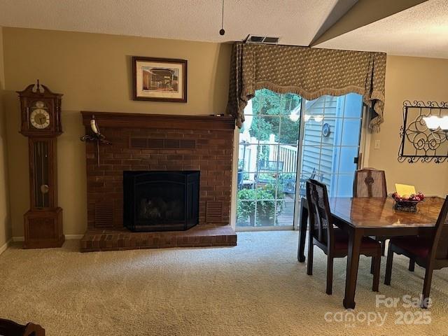 1678 Robins Nest Ct Unit B, Gastonia, NC 28054 - dining space with carpet flooring, a brick fireplace, and a textured ceiling