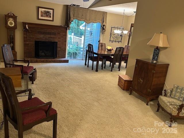 1678 Robins Nest Ct Unit B, Gastonia, NC 28054 - living room with carpet floors, a chandelier, and a brick fireplace
