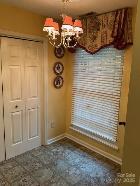 1678 Robins Nest Ct Unit B, Gastonia, NC 28054 - unfurnished dining area featuring a chandelier and baseboards