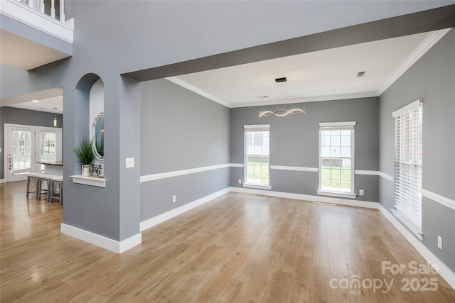 2002 Ledare Ln Unit 70, Indian Trail, NC 28079 - unfurnished living room featuring light wood-style flooring, a chandelier, and ornamental molding