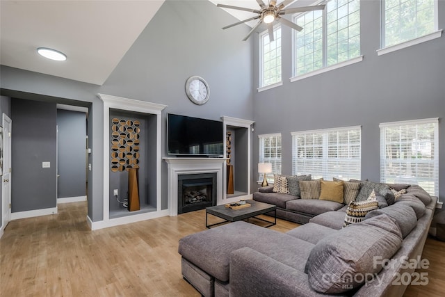2002 Ledare Ln Unit 70, Indian Trail, NC 28079 - living area with a high ceiling, a ceiling fan, light wood finished floors, and a fireplace